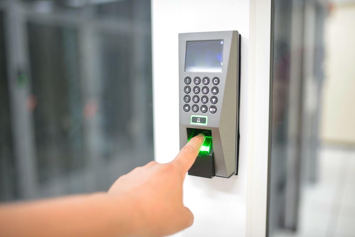 Fingerprint terminal beside a glass entrance